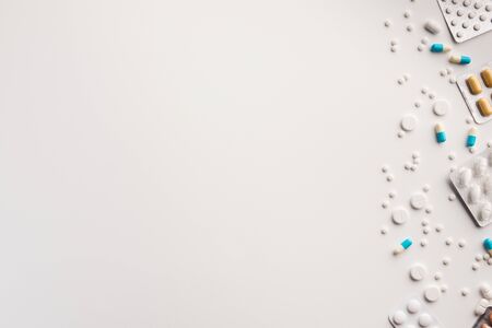 Tablets and blisters on white background. Flat lay.の写真素材