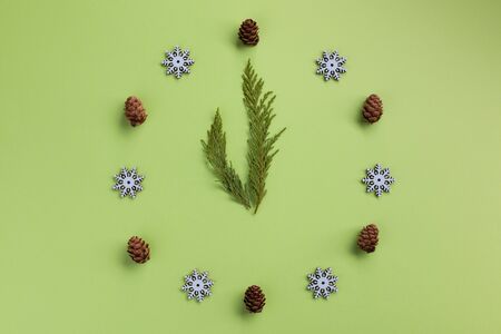 Christmas or New Year composition. Watch in the style of Christmas and New Year, on green background. Flat lay, top view, copy space.の写真素材