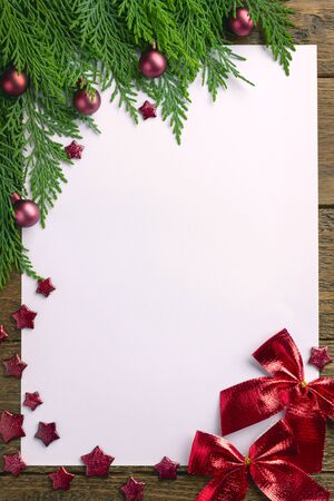 Holiday Christmas card with fir tree and festive decorations balls, stars on wood background. Christmas template for banner, ticket, leaflet, card, invitation, posterの写真素材