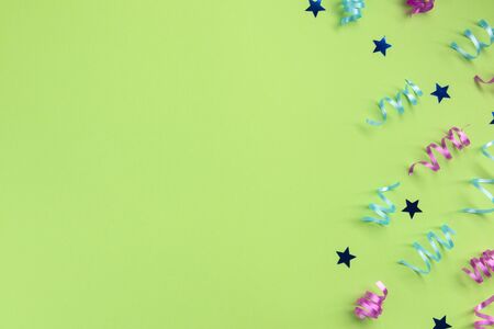 Serpentine and stars, on green  background. Celebration concept .Flat lay, top view, copy space.の写真素材