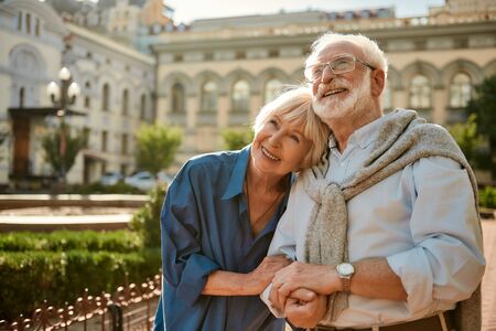 We love to travel together. Happy senior couple bonding to each other and smiling while standing outdoors. Family. Love conceptの写真素材