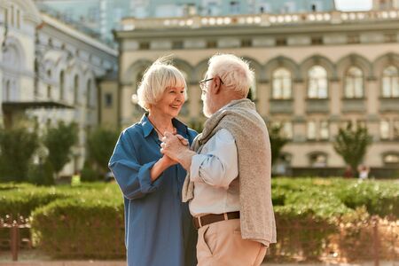 Forever together. Happy senior couple dancing and smiling while standing outdoorsの写真素材