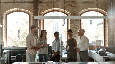 Business team. Group of modern people discussing something at business meeting while standing in the modern office. Teamwork. Web bannerの写真素材