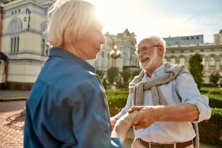 Spend life with people who make you happy. Beautiful and cheerful senior couple dancing together outdoors on a sunny day. Having fun. Love conceptの写真素材