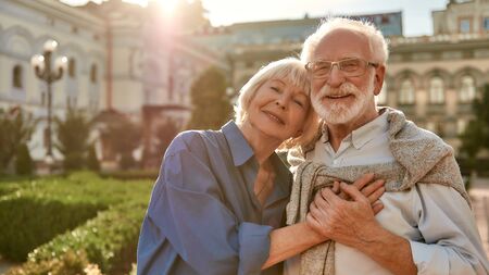 Portrait of beautiful happy senior couple bonding to each other and holding hands while standing in the park together. Family. Love conceptの写真素材