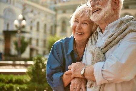 Always together. Happy senior couple bonding to each other and smiling while spending time together outdoors. Family. Love conceptの写真素材