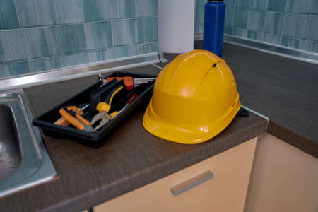 Helmet and repair tools lying on tableの写真素材