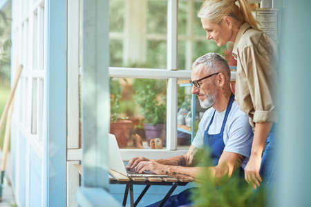 Middle aged caucasian couple working on laptopの写真素材