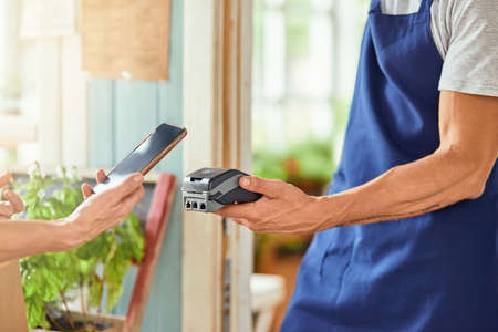 Using smartphone for contactless payment at shop