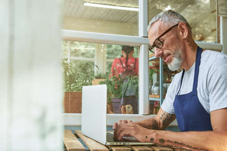 Middle aged caucasian businessman working on computerの写真素材