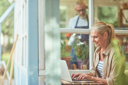 Middle aged caucasian woman working on laptopの写真素材