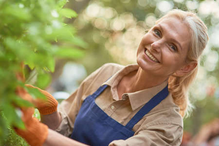 Middle aged caucasian business woman in gardenの写真素材