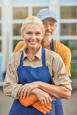 Beautiful middle aged caucasian man and woman huggingの写真素材