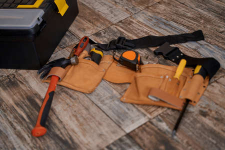 Belt with repair tools lying on floorの写真素材
