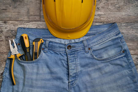 Protective helmet and tools in jeans pocketの写真素材
