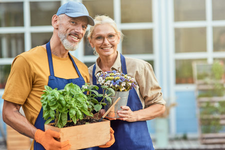 Middle aged spouses smiling on garden house backgroundの写真素材