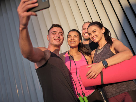 Smiling young multiracial sportive people taking selfieの写真素材