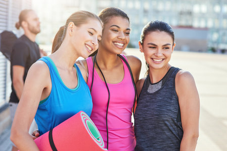 Portrait of pretty young fitness girls standing togetherの写真素材