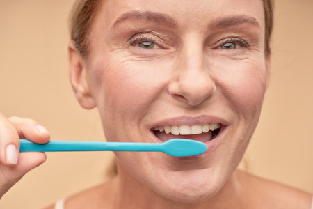 Happy beautiful woman brushing teeth in the morningの写真素材