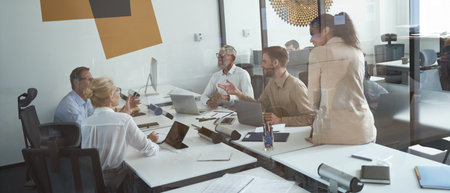 Group of multiracial business people sharing ideas while having a meeting in conference room, working together in the modern office or coworking spaceの写真素材