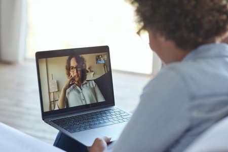 Close up shot of laptop screen. Young female teacher having online lesson with teen schoolgirl via video chat app during lockdownの写真素材