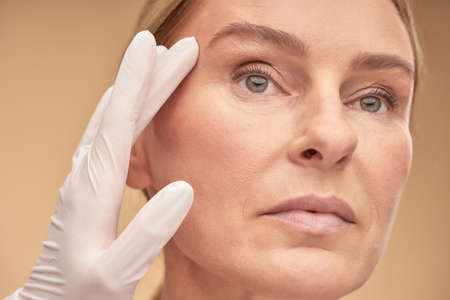 Mature lady showing result after cometological treatmentの写真素材