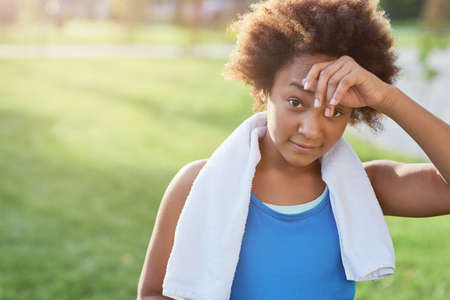 Sporty Afro American girl standing on the streetの写真素材
