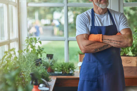 Middle aged caucasian man standing in greenhouse