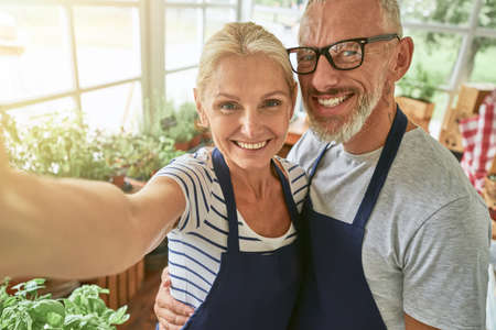 Selfie of middle aged caucasian couple in garden house