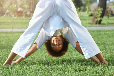 Adorable female child karateka doing exercise outdoorsの写真素材