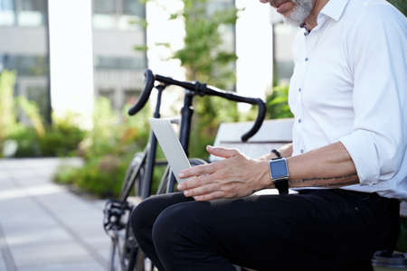 Focus on your goals. Cropped shot of modern middle aged businessman in white shirt working on his...