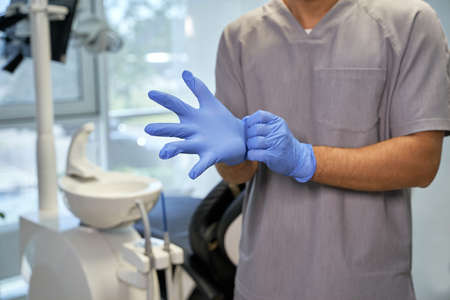 Medical worker using disposable gloves at dental clinicの写真素材