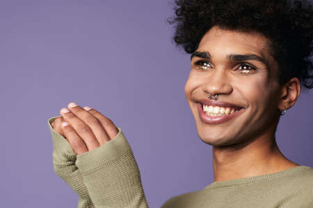 Portrait close up of young transgender man smile. Sensual male with black hair in casual t-shirtの写真素材