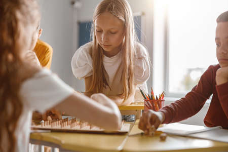Kids using geoboard together in classroom in schoolの写真素材