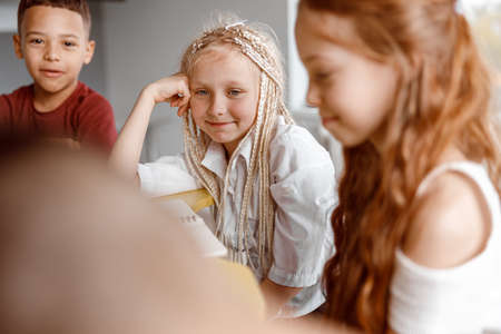 Smiling schoolchildren spending time on lessons with interestの写真素材