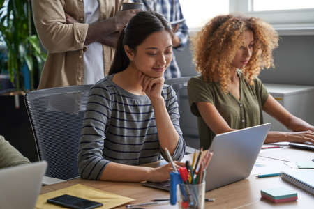 Businesswomen writing graphs and charts for statementsの写真素材