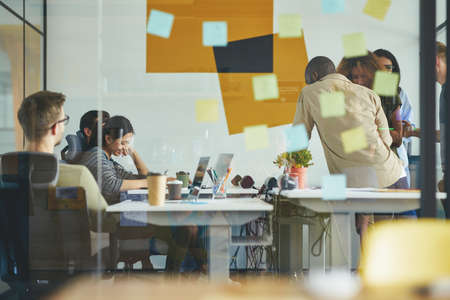 Young professionals working on task solution togetherの写真素材