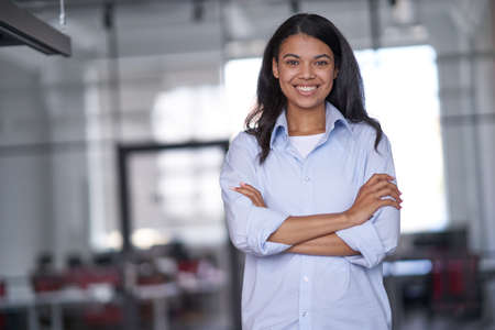 Smiling businesswoman waiting for clients in conference roomの写真素材