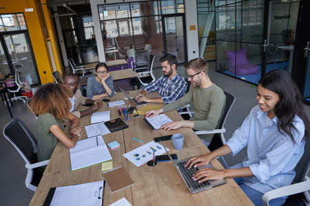Young people speaking about financial statement together in conference room togetherの写真素材