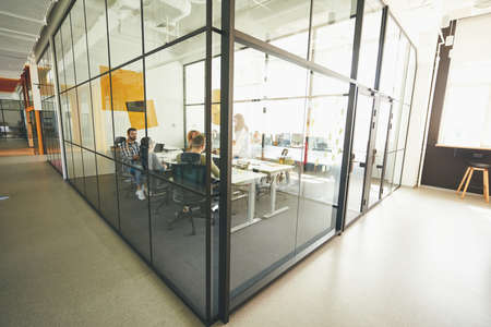 Industrious young people working in a cozy modern glass officeの写真素材