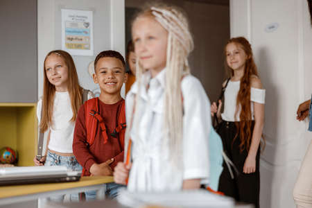 Smiling kids standing in class at schoolの写真素材