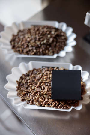 Coffee beans and black box on metal electronic scalesの写真素材
