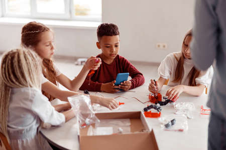 Schoolchildren constructing model with constructor details in schoolの写真素材