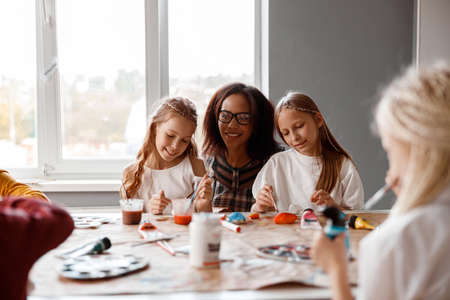 Smiling kids making art painting using water colorsの写真素材