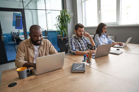 People doing new financial projects on modern computersの写真素材