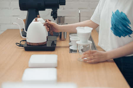 Female barista making filter coffee in cafeteriaの写真素材
