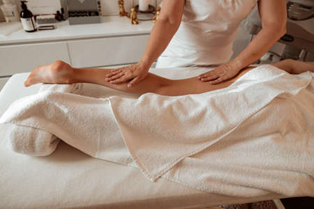 Female client receiving therapeutic massage at wellness centerの写真素材