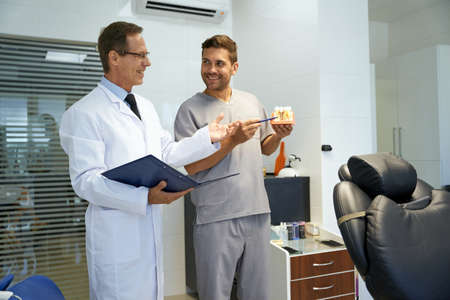 Two male dentists having a professional discussion at clinicの写真素材