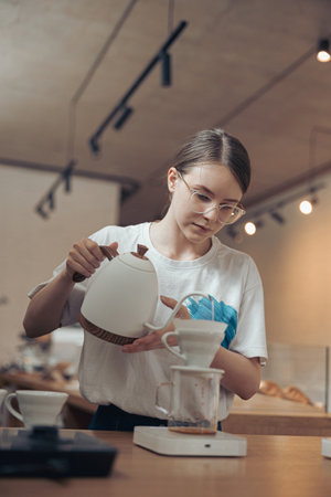 Nice female barista making filter coffee in cafeteriaの写真素材