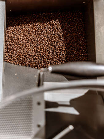 Coffee beans in metal container of coffee roasting machine